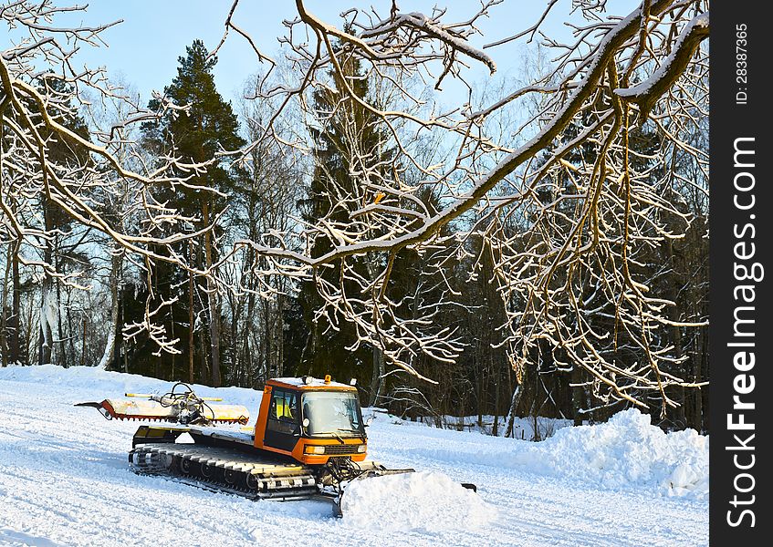 Big snowplow machine on a ski slope. Big snowplow machine on a ski slope