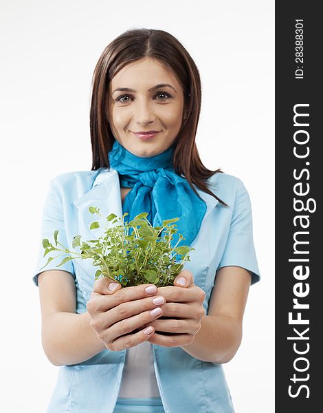 Attractive female presenting green herbs. Attractive female presenting green herbs