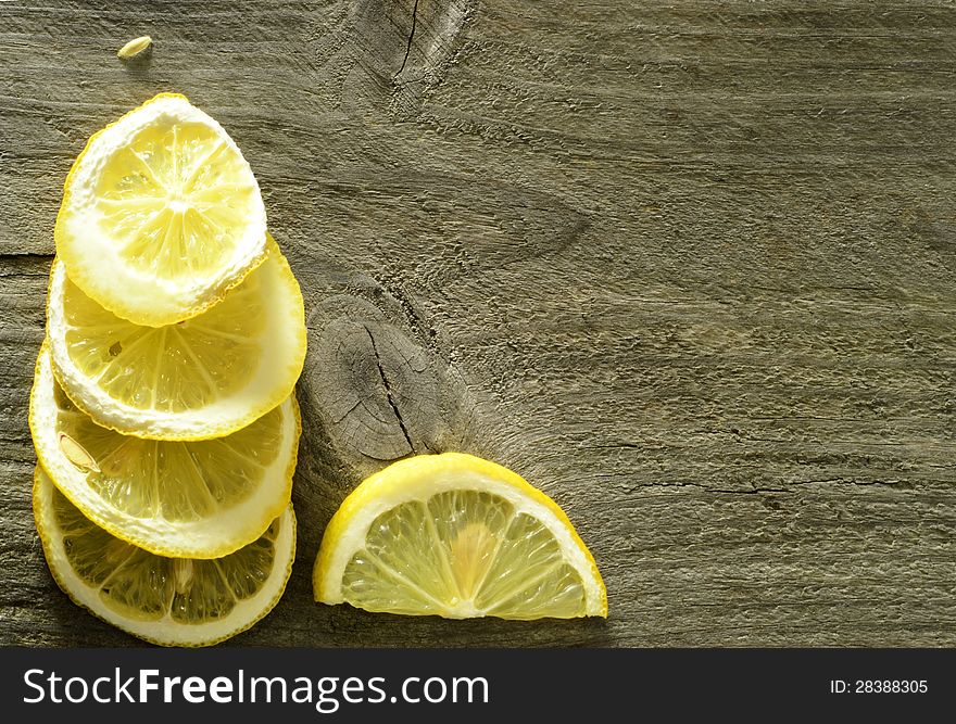 Dry and sliced lemon on the wooden background, rustic. Dry and sliced lemon on the wooden background, rustic