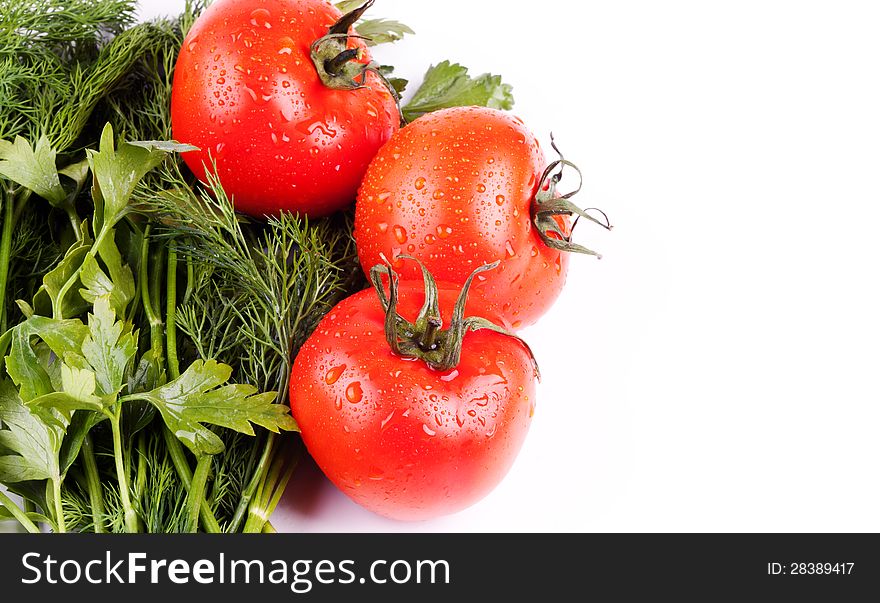 Ripe tomatoes in drops and greens