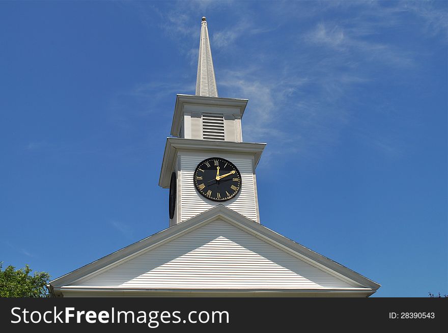 A magnificent tower clock with a blue sky background. A magnificent tower clock with a blue sky background