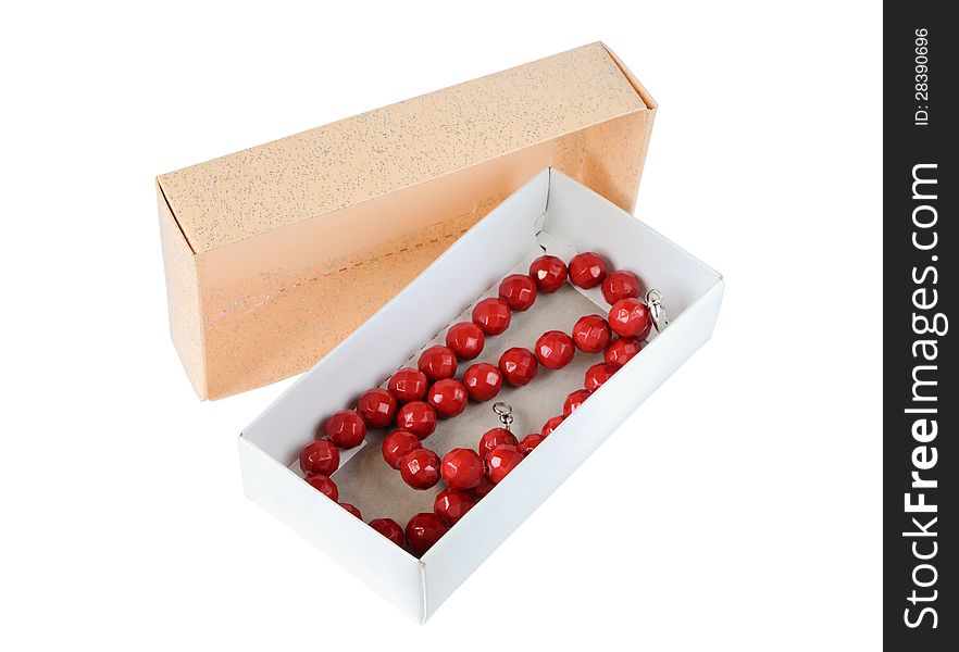 Coral necklace in a paper box isolated on white