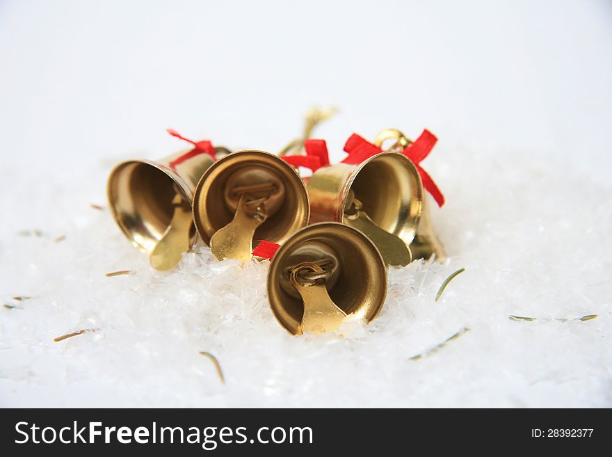 Christmas bells with golden stars in snow