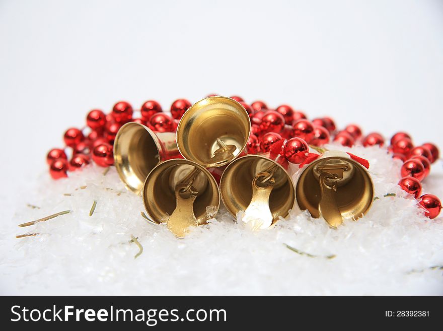 Gold christmas bells on snow. Gold christmas bells on snow