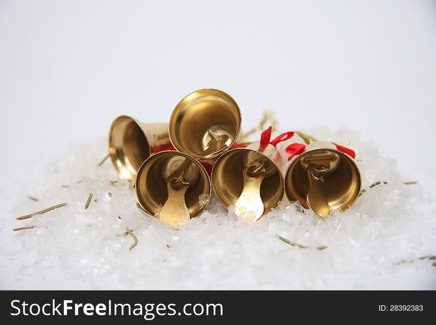 Gold christmas bells on snow. Gold christmas bells on snow