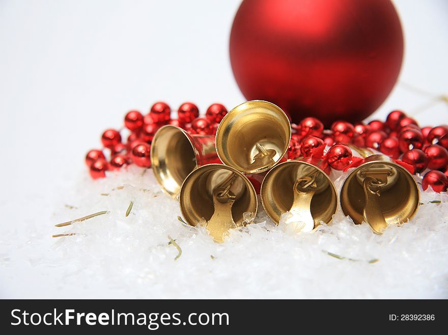 Gold christmas bells on snow. Gold christmas bells on snow