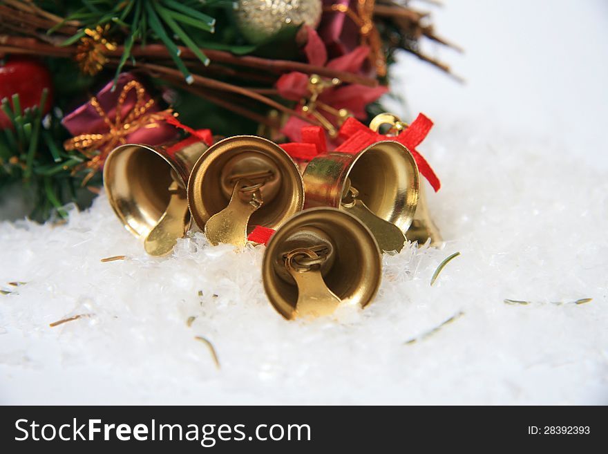 Gold christmas bells on snow. Gold christmas bells on snow