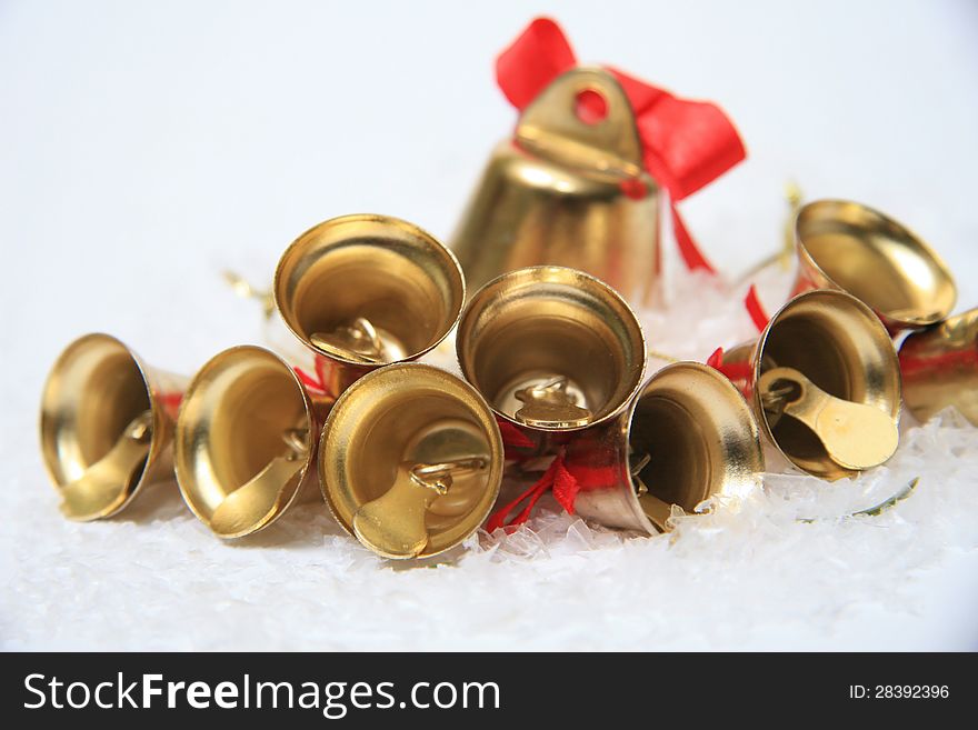 Gold christmas bells on snow. Gold christmas bells on snow