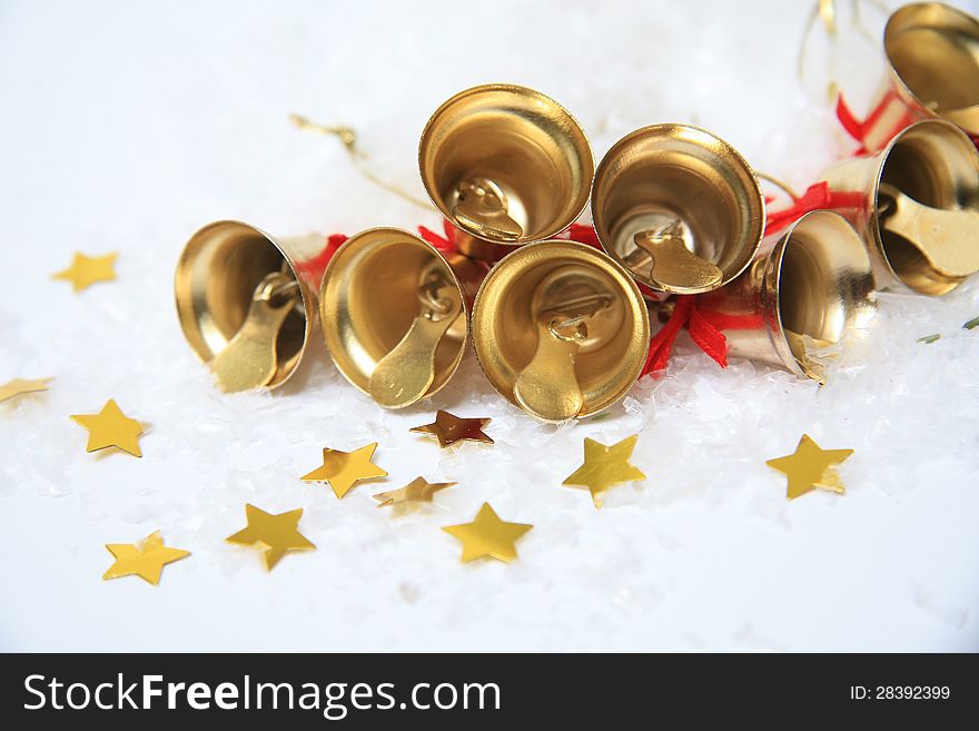 Christmas bells with golden stars in snow. Christmas bells with golden stars in snow