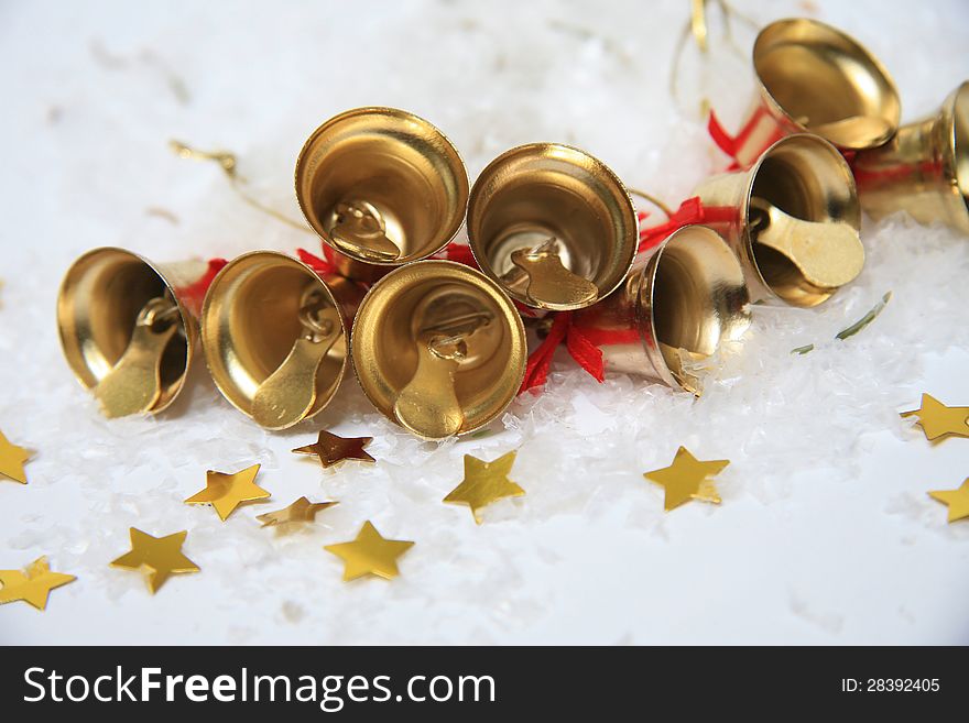 Christmas bells with golden stars in snow. Christmas bells with golden stars in snow