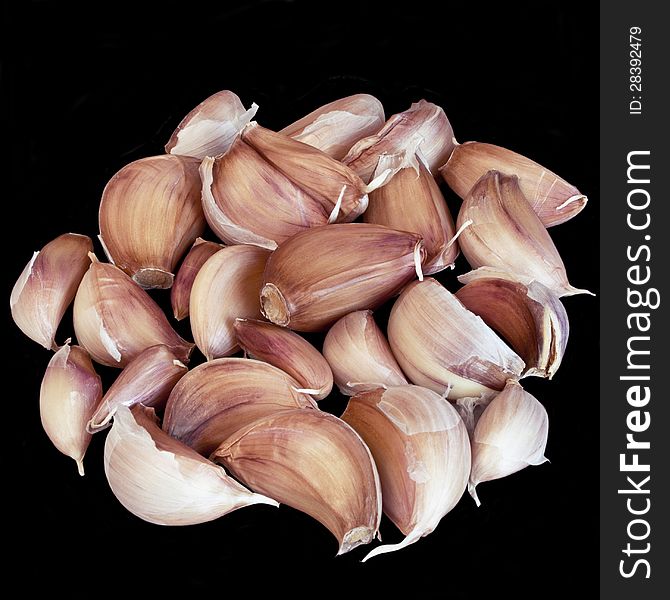 Heap of bulb ripe garlic isolated over black background. Heap of bulb ripe garlic isolated over black background