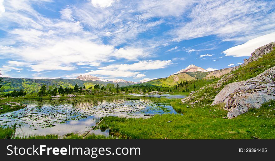 The sky reflects off of the surface of Beaver Lagoon in the San Juan Mountains in Colorado.