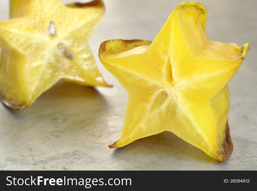 Closeup of beautiful fresh cut star fruit on grey table