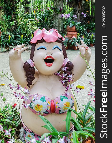 Beautiful Fat Lady Sculpture With Various Orchids In Garden