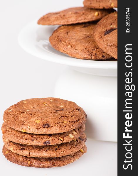 Cookie with chocolate pieces on white background