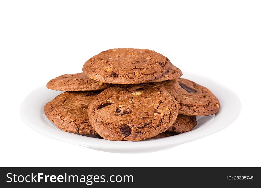 Cookie with chocolate pieces on white background