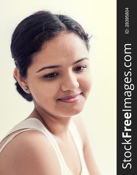 Attractive teenage indian girl smiling and looking down embarrassed. Attractive teenage indian girl smiling and looking down embarrassed.