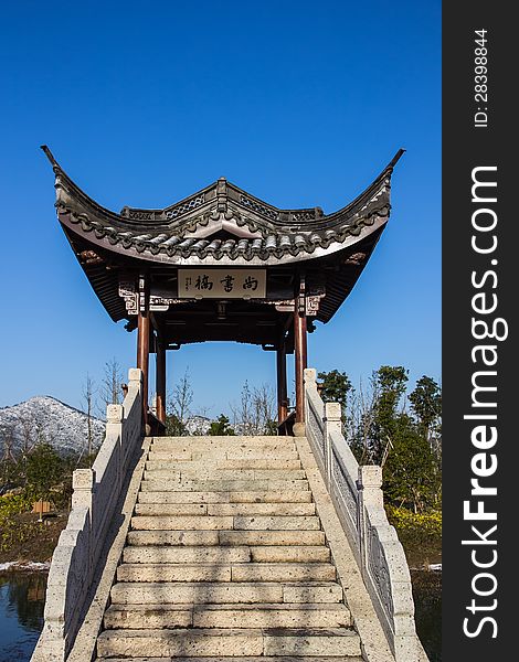 A very nice pavilion under the blue sky, shot in the Xiang Lake. There is also one hill covered by the snow indicate that this picture is taken in the winter. A very nice pavilion under the blue sky, shot in the Xiang Lake. There is also one hill covered by the snow indicate that this picture is taken in the winter.