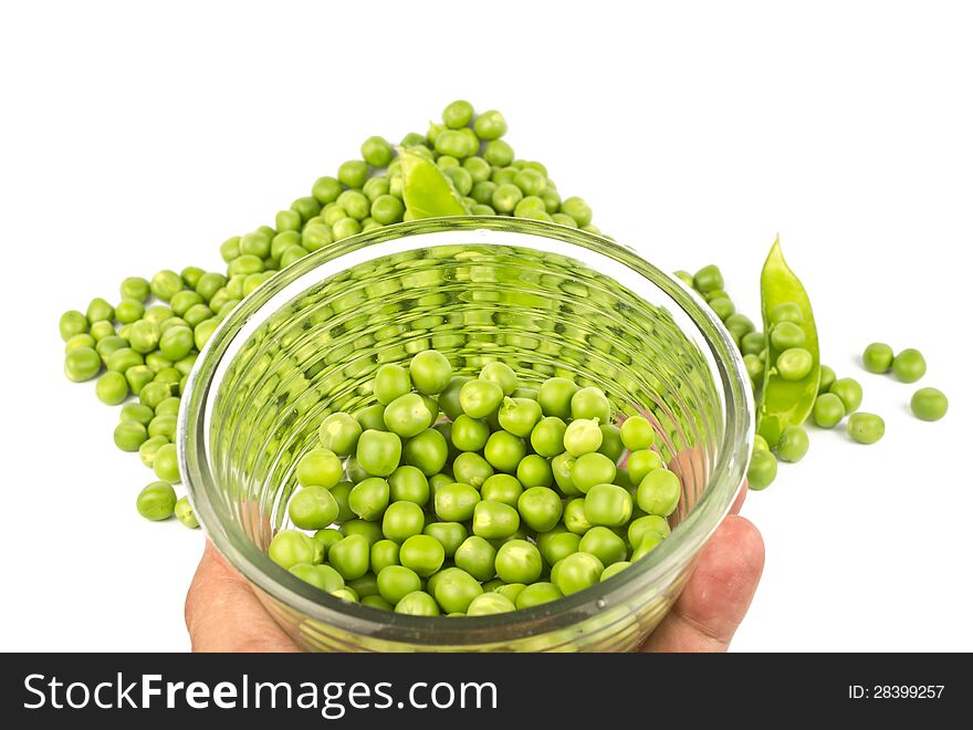Pea balls in glass bowl and their heap on white background.
