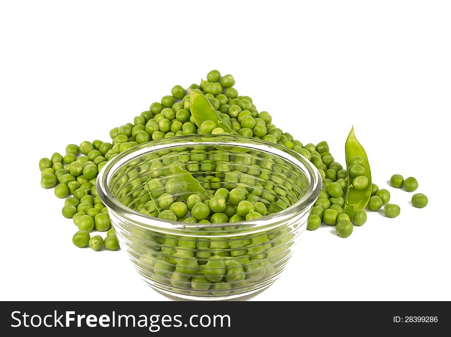 Pea balls in glass bowl and their heap on white background.