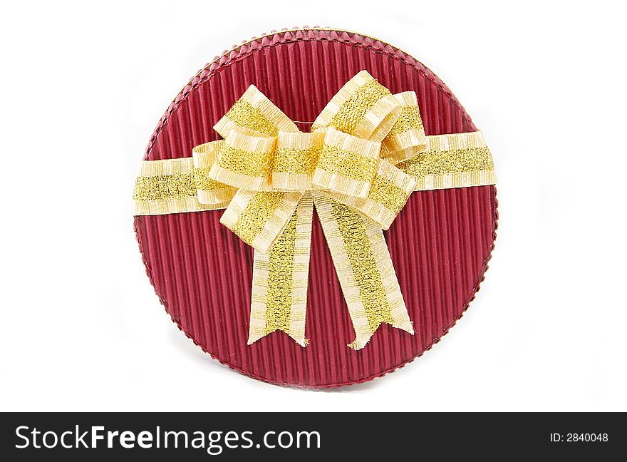 Red present box with gold ribbon on white background