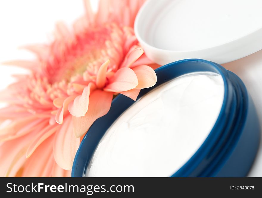 Face cream with flower isolated on white background