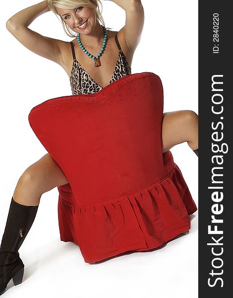 Pretty girl in sexy outfit sitting on red chair with a alluring expressin on her face. Pretty girl in sexy outfit sitting on red chair with a alluring expressin on her face