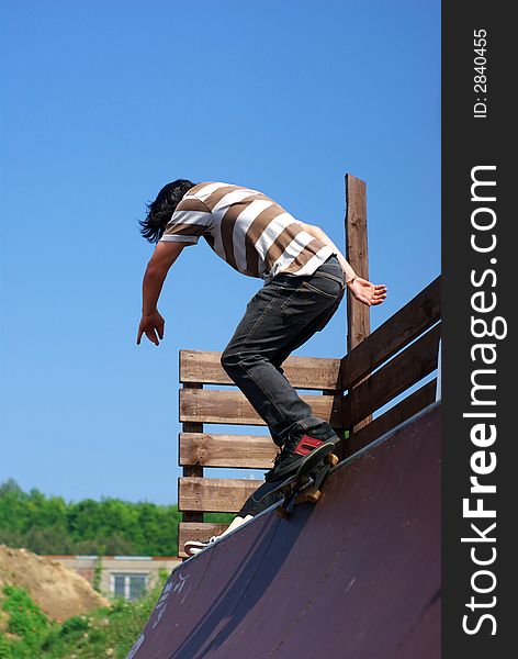 Skateboarder performing in a mini ramp. Skateboarder performing in a mini ramp.