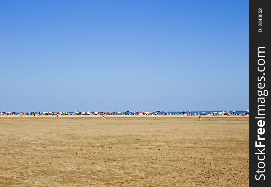 Line of colored sunshades on the beach. Line of colored sunshades on the beach
