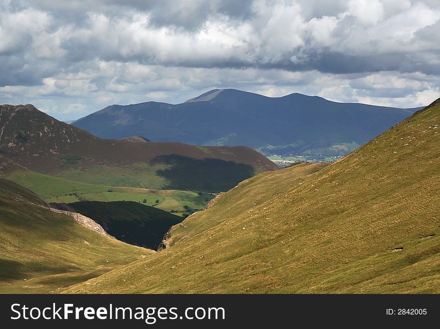 A view of a distant Skiddaw and Northern Fells from Littledale Edge in the English Lake District. A view of a distant Skiddaw and Northern Fells from Littledale Edge in the English Lake District