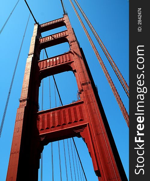 Looking up at a tower of the Golden Gate Bridge in San Francisco