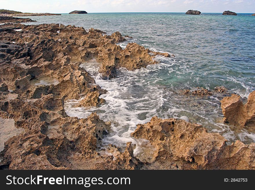 Volcanic rock coastline of a small island in the Caribbean Sea.