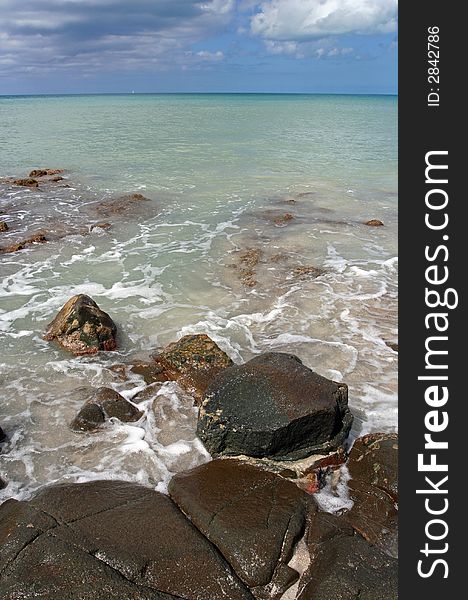 Beautiful Caribbean beach shore with large rocks and clear turquoise water. Beautiful Caribbean beach shore with large rocks and clear turquoise water.