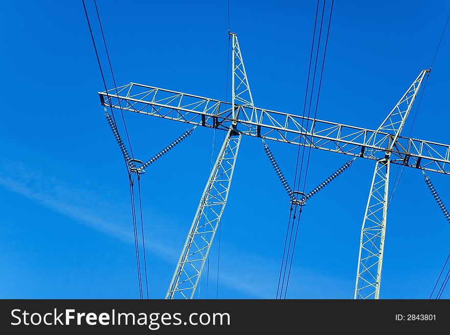 Power lines towers against a blue sky
