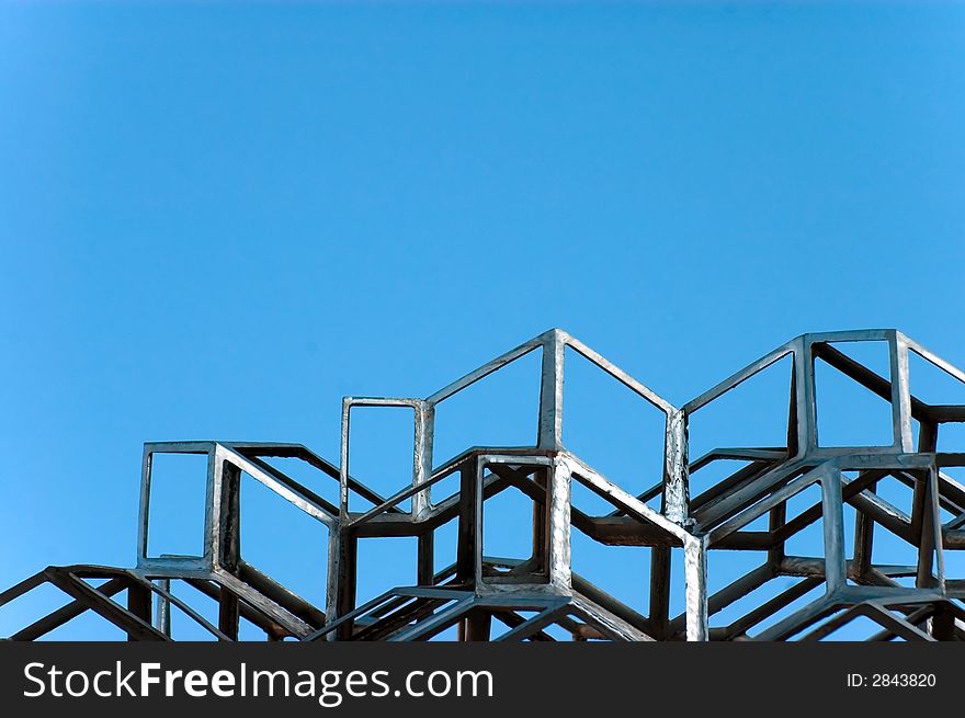 An abstract sculpture against a blue sky