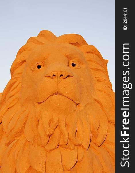 Lion head made from sand against a blue sky. Lion head made from sand against a blue sky