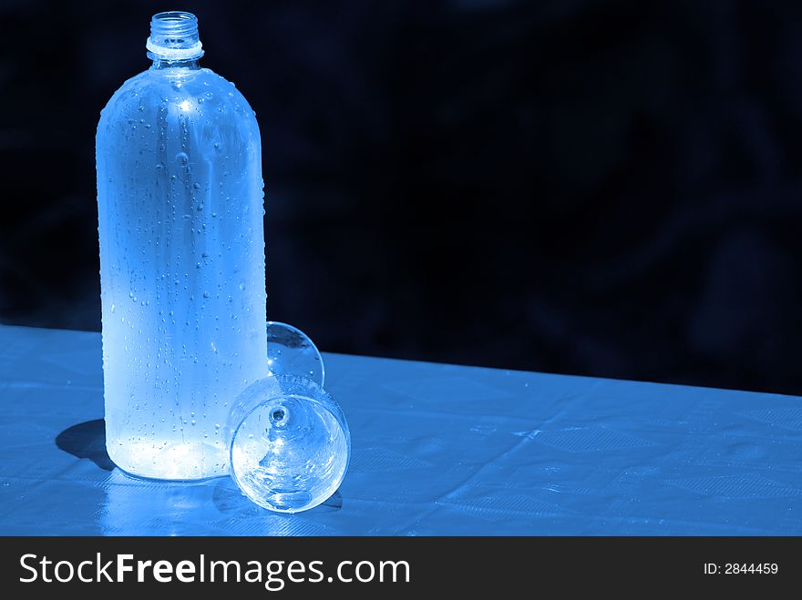 Bottle with glass and tablecloth. Bottle with glass and tablecloth