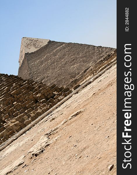 The great pyramids of Giza in Egypt, one pyramid is showing and part of anotehr one. Shot with an angle to give a different feeling. The great pyramids of Giza in Egypt, one pyramid is showing and part of anotehr one. Shot with an angle to give a different feeling...