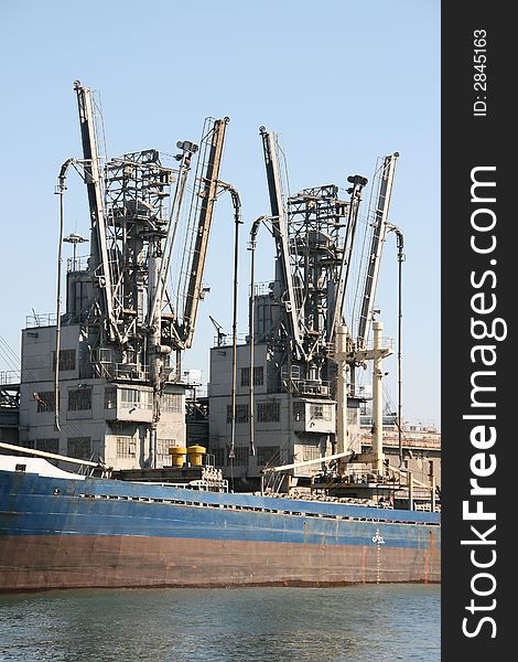 Ship loading equipment at the port of piraeus athens greece. Ship loading equipment at the port of piraeus athens greece