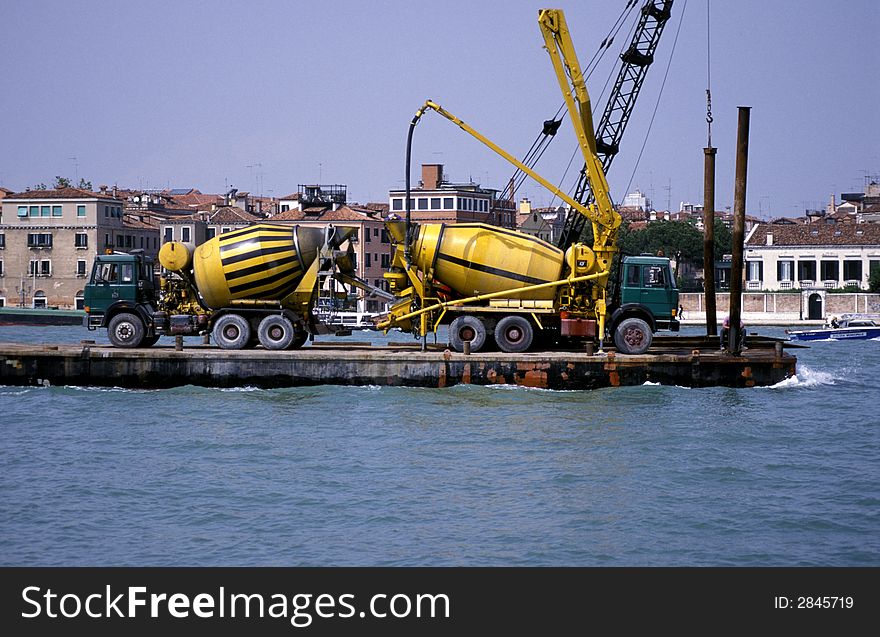 Two cement mixers on a barge arriving in Venice. Two cement mixers on a barge arriving in Venice.