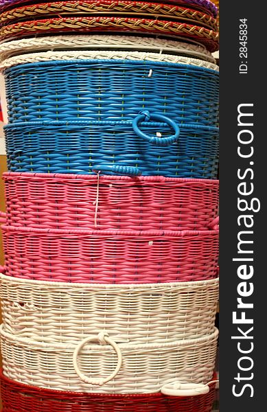 A stack of colorful baskets in a retail store. A stack of colorful baskets in a retail store