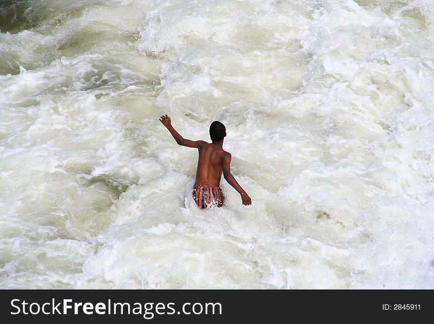 Black boy in the surf. Black boy in the surf