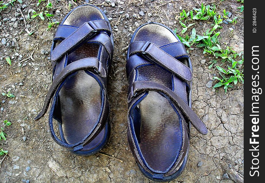 A pair of sandals belong to a tourist enjoying his holidays time. A pair of sandals belong to a tourist enjoying his holidays time