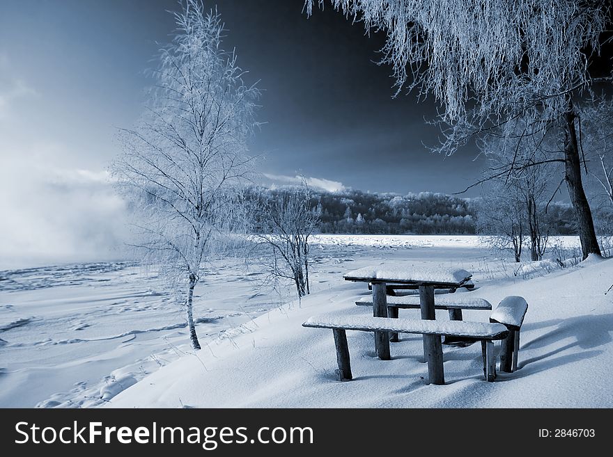 Little table and bench on coast of the river