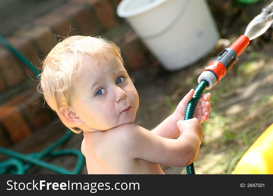 Boy with water hose