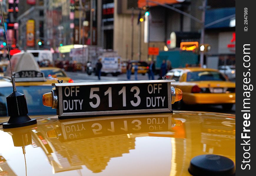 Downtown yellow cab, showing reflection of Manahtten buildings. Downtown yellow cab, showing reflection of Manahtten buildings