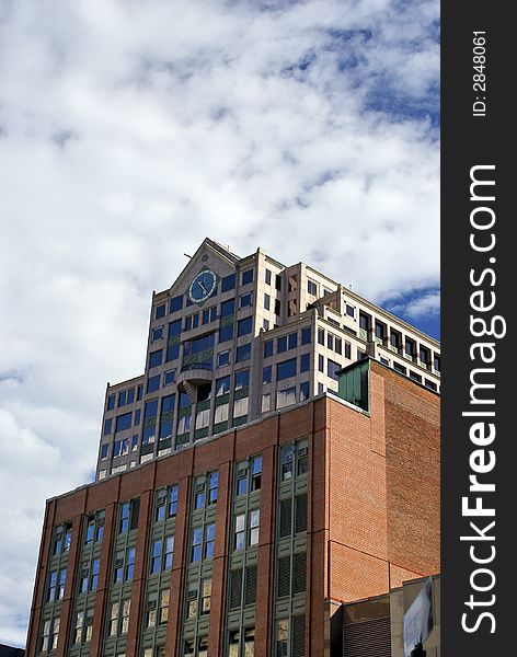 Old boston skyscraper surrounded by clouds and a deep blue sky. Old boston skyscraper surrounded by clouds and a deep blue sky