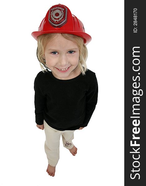 Beautiful six year old girl in toy dress up fire hat