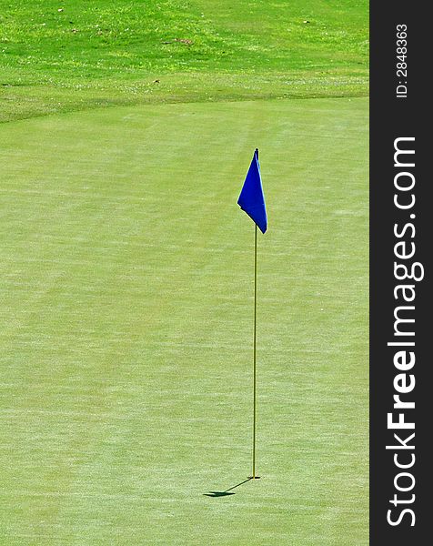 Blue flag on the 18th hole of a golf course