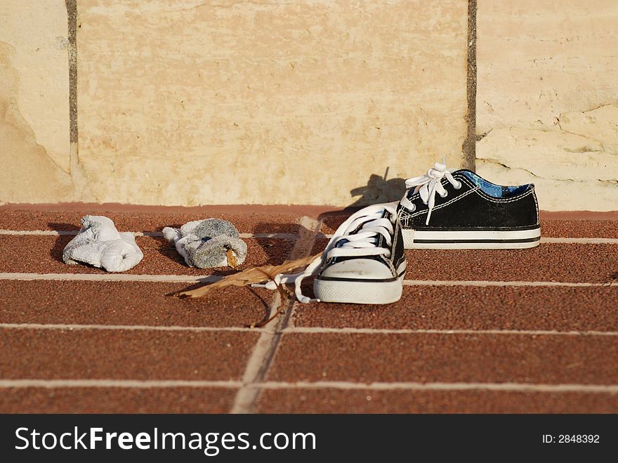 Color photo child sneakers on brick ground.